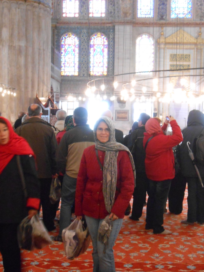 Deirdre in the Blue Mosque with required head scarf and carrying our shoes